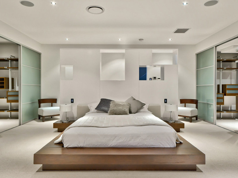 luxurious-modern-homes-with-white-bedding-wooden-bed-beside-table-white-table-lamps-white-sofa-lighting-fixtures-sliding-door