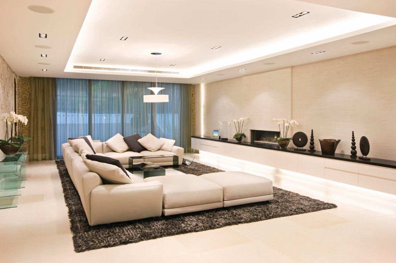 marvelous-u-shaped-cream-comfy-sofa-design-ideas-cream-brown-cushions-round-white-chandelier-and-ceiling-lamps-black-bulbs-table-decorations-natural-wooden-vase-with-white-flowers-black-white-fury-rug