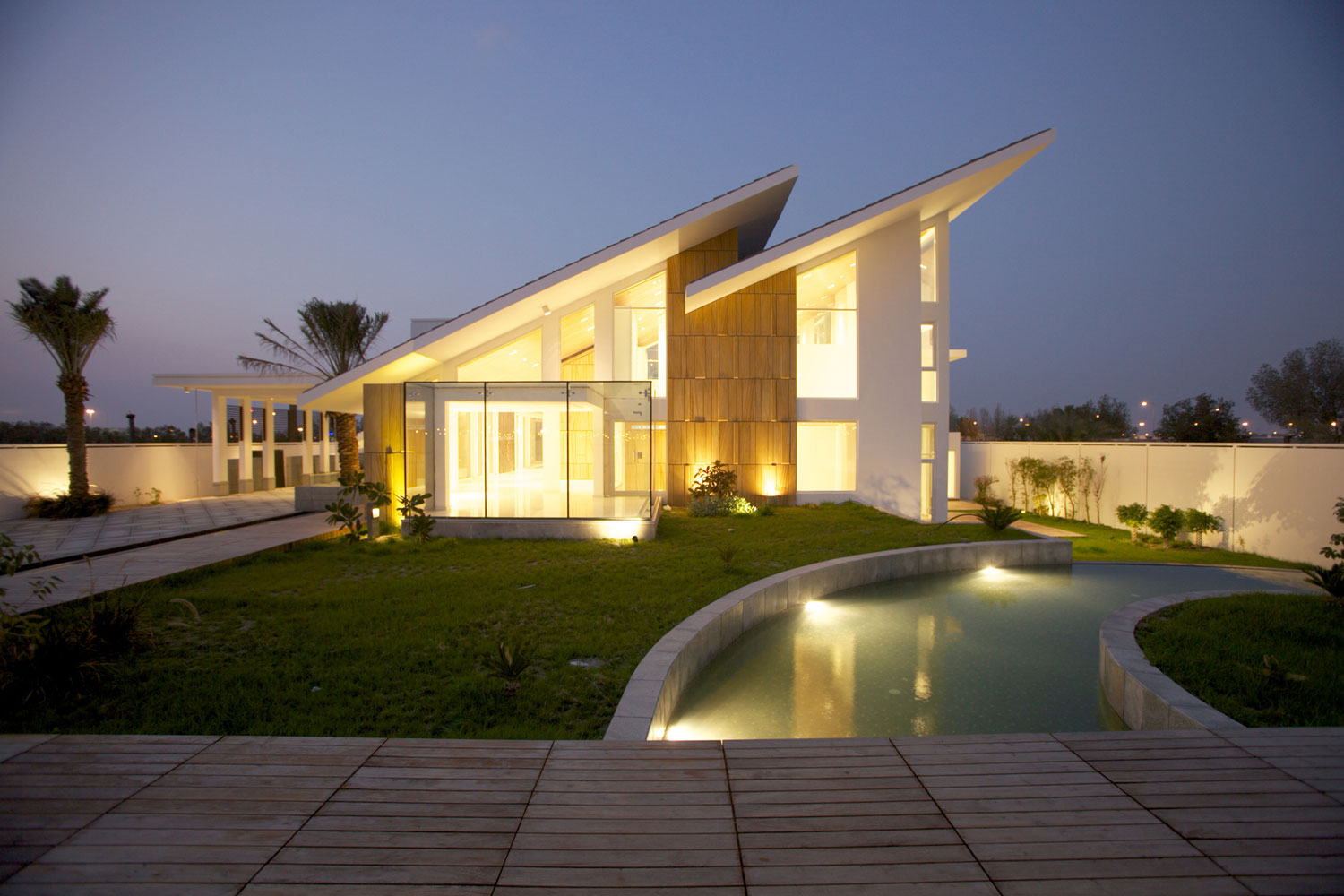side-modern-house-with-white-exterior-color-and-sloping-roof-design-and-outdoor-pool-lighting-ideas