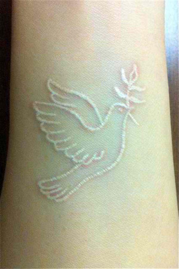white-ink-tattoos-dove-wrist-design