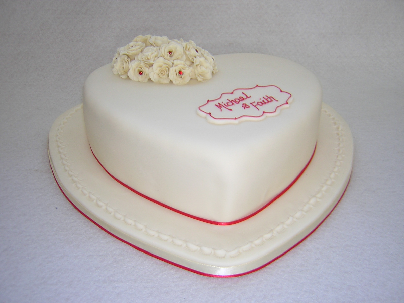 Heart shaped white icing anniversary cake