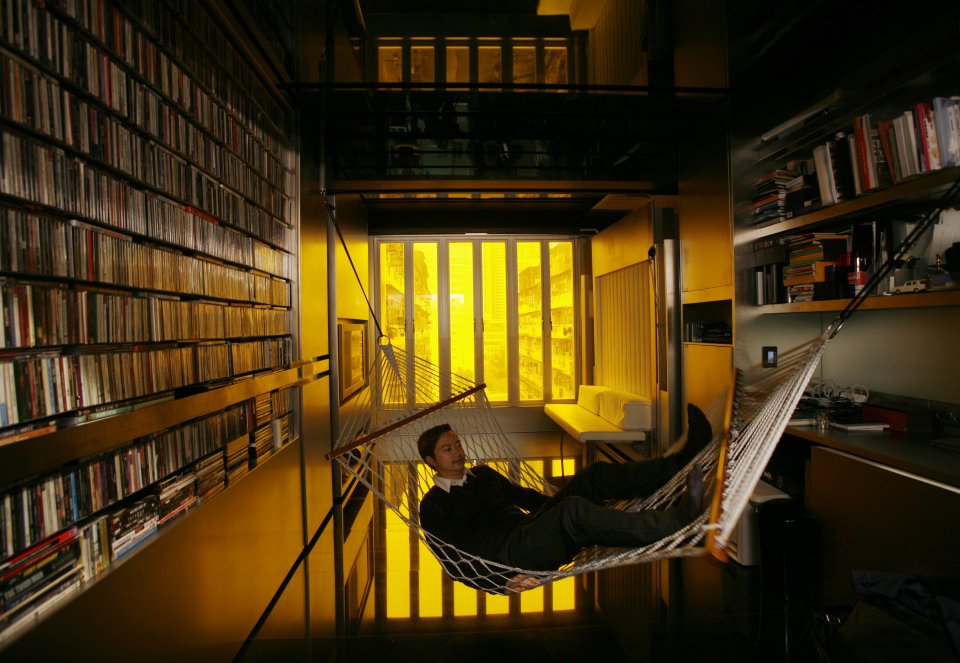hong-kong-architect-gary-chang-rests-in-a-hammock-inside-his-330-square-feet