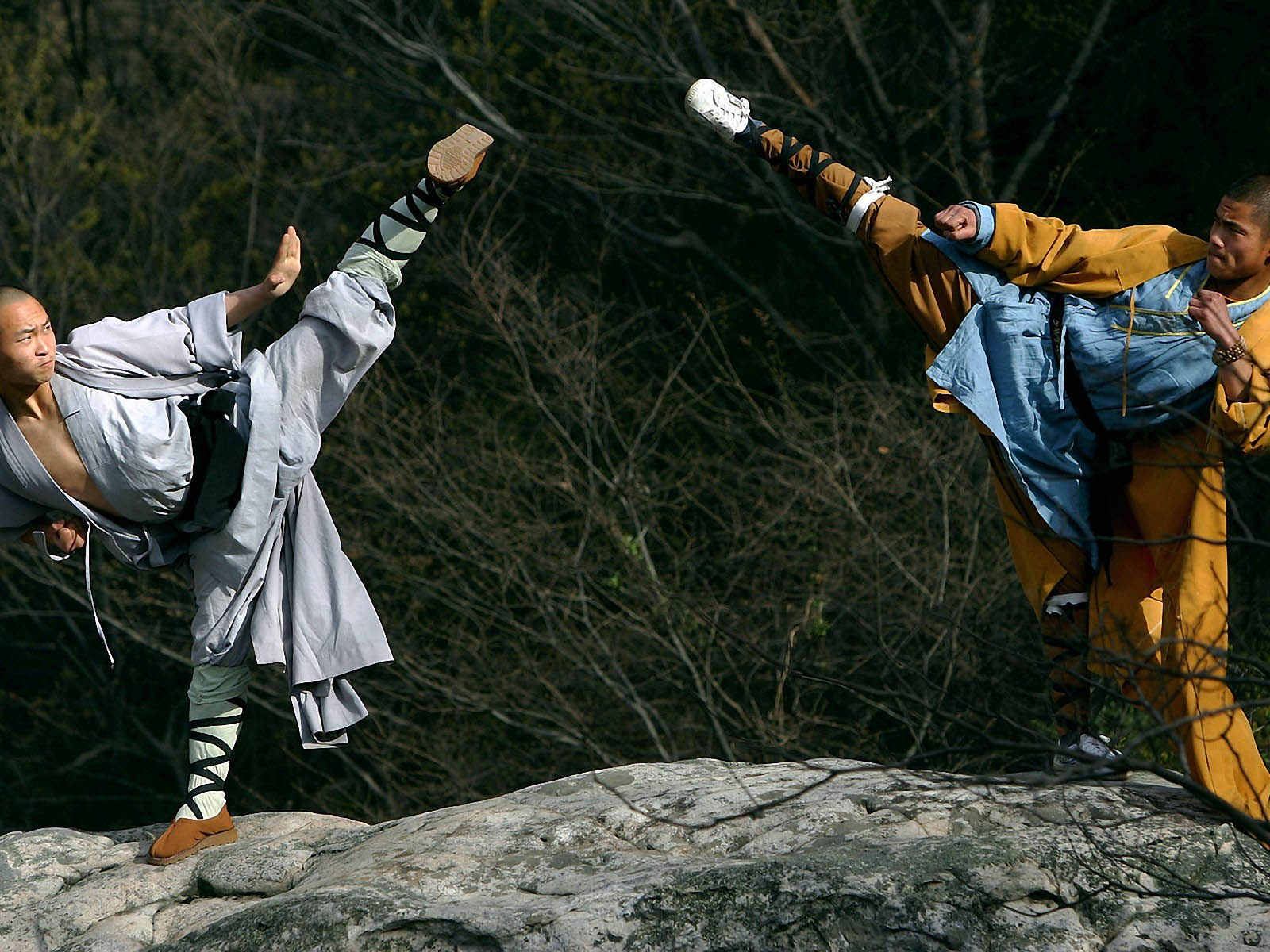 Warrior monks of the Shaolin Temple display their Kung Fu skills at the Songshan Mountain near the temple April 12, 2005 in Dengfeng, Henan Province, China. Shaolin Temple, built in AD 495 in the period of the Northern and Southern Dynasties (420-581) and located in the Songshan Mountain area, is the birthplace of Shaolin Kung Fu. Shaolin Kung Fu, with its incredible strength, vitality and flexibility, is expecting to be included in the UNESCO intangible heritage list.