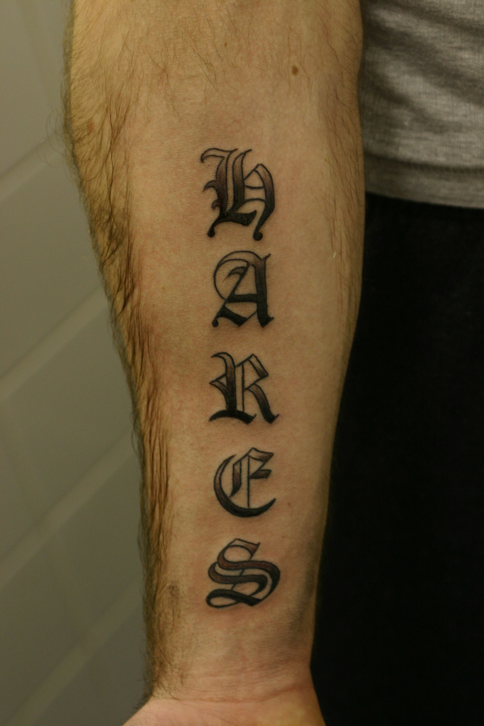 old english lettering shaded tattoo forearm