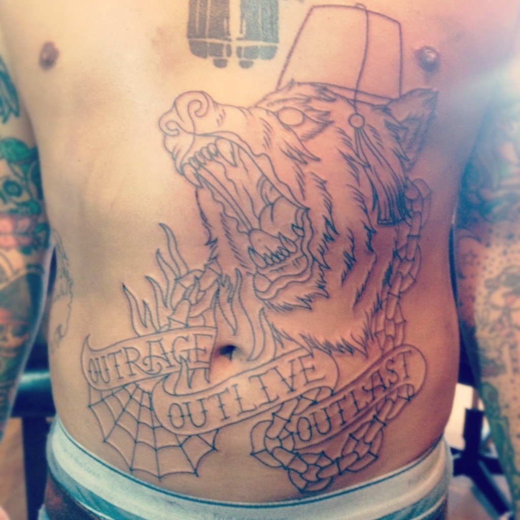 Bear cover up stomach tattoo