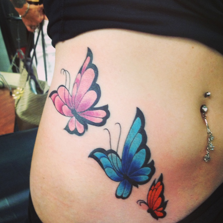 Butterfly tattoo on side of stomach