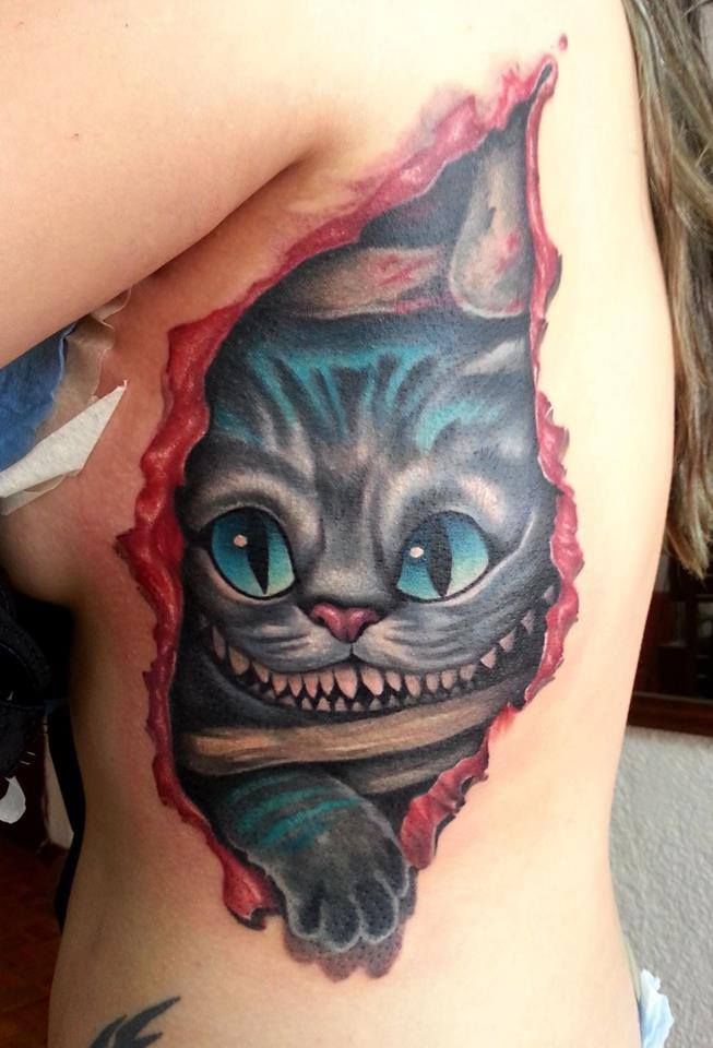 Creepy cheshire cat tattoo in skin rip