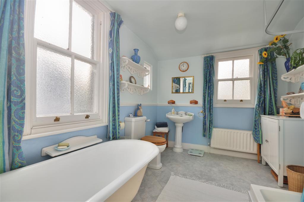colourful traditional blue white bathroom with bath roll top bath
