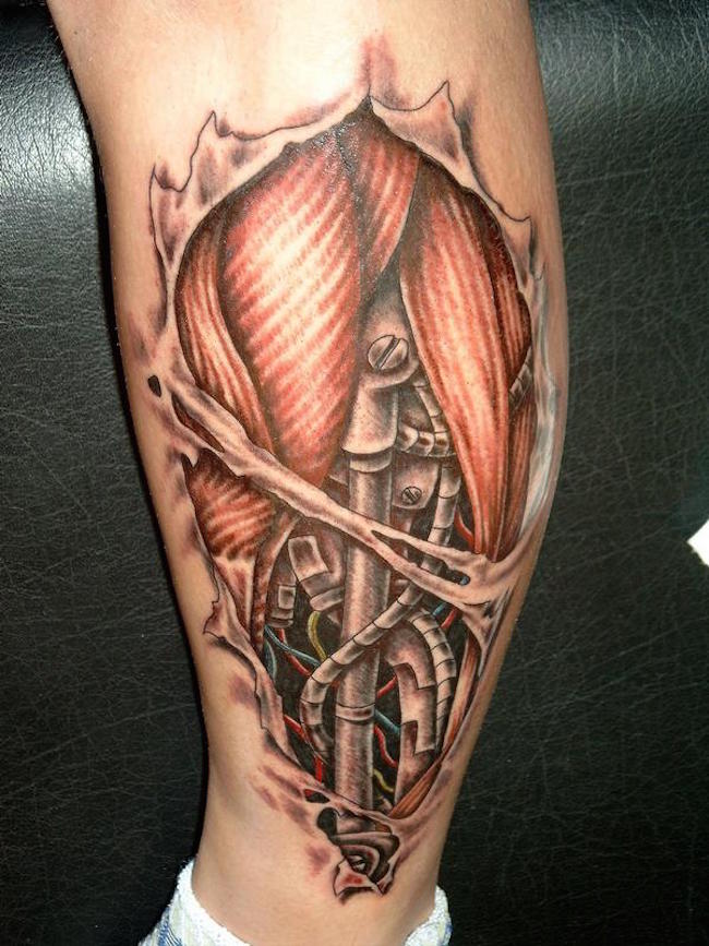 grey ink biomechanical tattoo on left leg