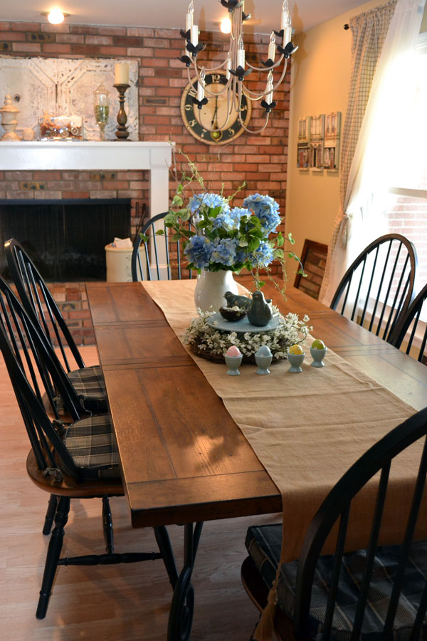 Country Style Dining Room Design Ideas With Brick Wall Accent And Traditional Fireplace Featuring Farmhouse Dining Table