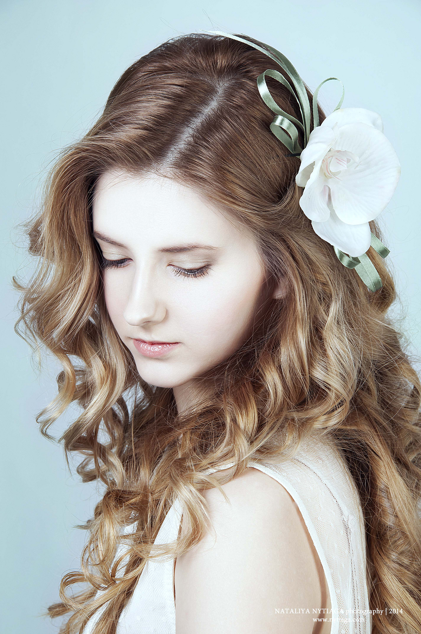 Romantic young woman with long curly blond hair