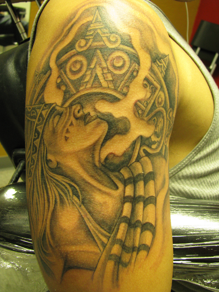 Tattoo of an aztec princess and calendar on arm