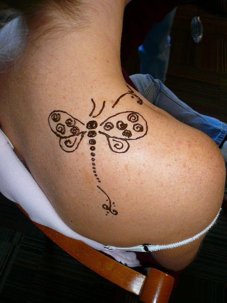 dragonfly on her shoulder