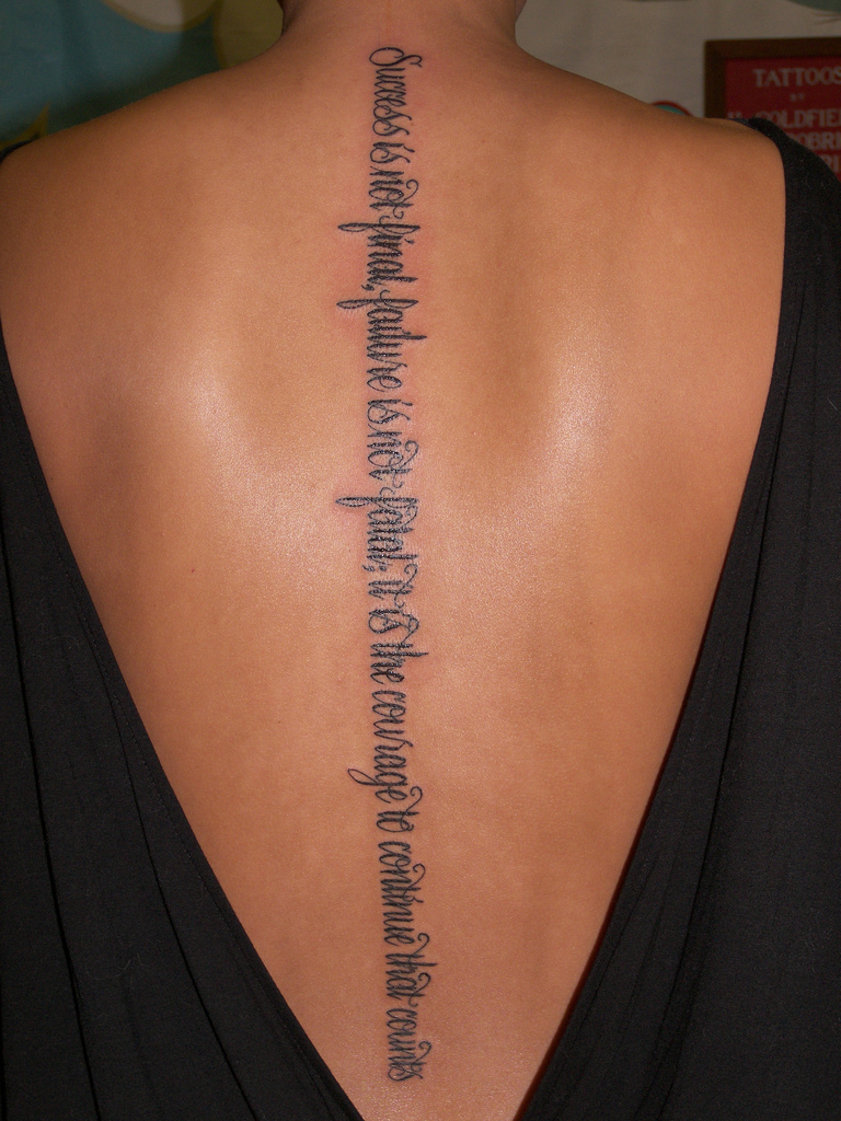 lettering tattoo on spine