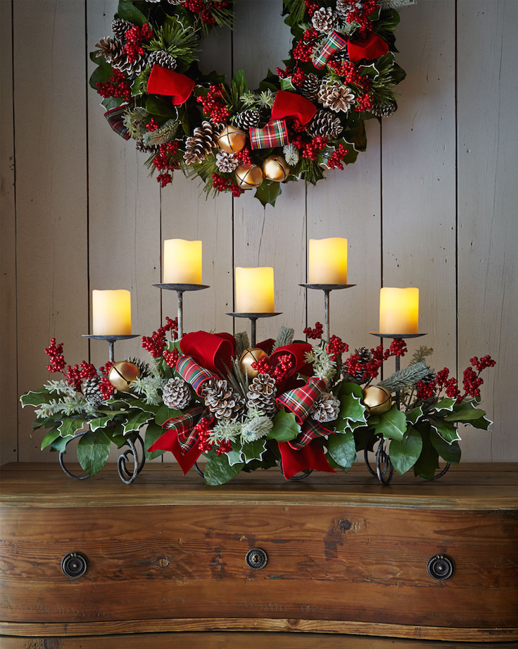 indoor christmas decoration with iron candlestick and wood table with flower ornament also ball
