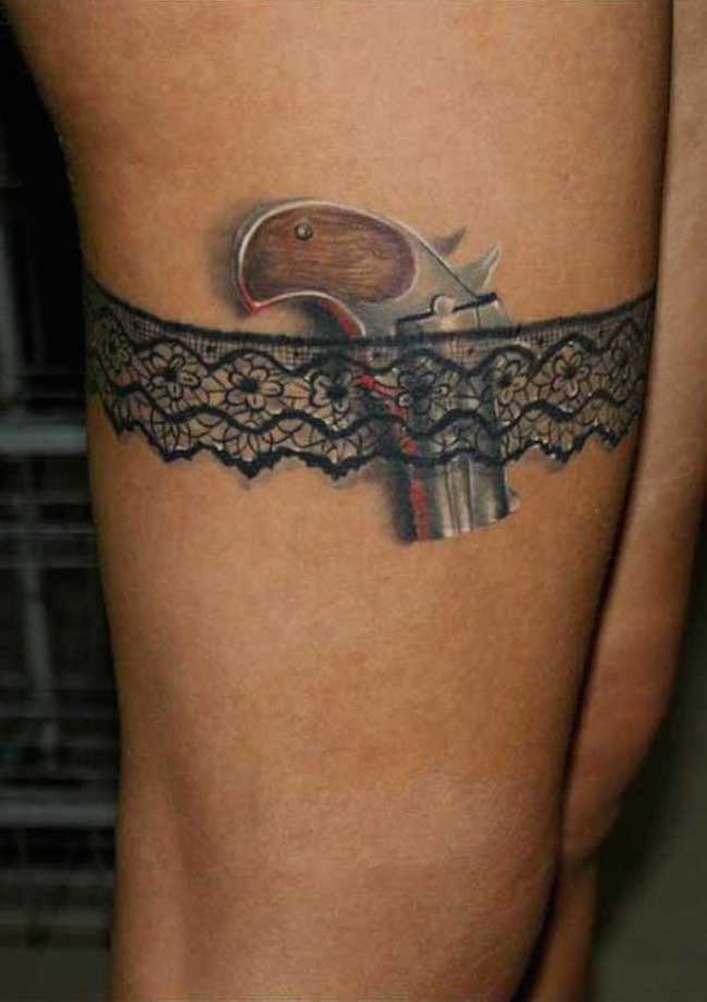 Sexy little gun in garter tattoo