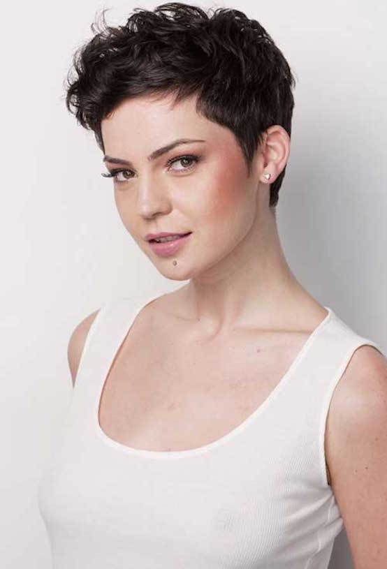 A Dark Brown Curly Pixie Cut with Slight Sideburns