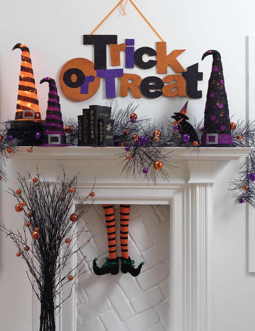 orange and purple Halloween mantel decor with witch legs