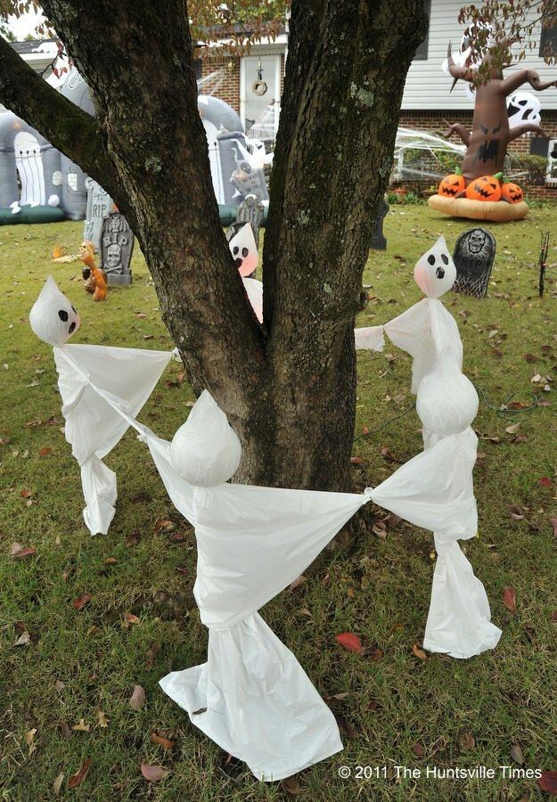 White Ghosts Surrounding Tree To Create Spooky Halloween